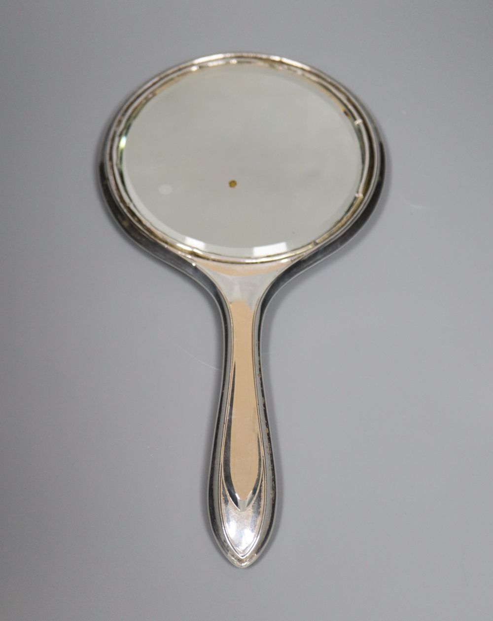 A silver-mounted conical glass scent bottle, sundry other silver-mounted toilet items and an engine-turned silver compact.